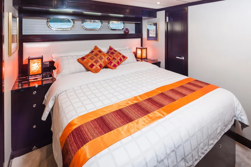  Yacht Photos Pics Luxurious bedroom in 2013 Nordhavn 68 yacht with elegant decor and vibrant accents.