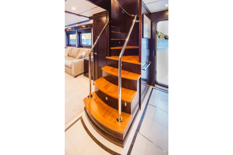  Yacht Photos Pics Luxurious wooden staircase inside 2013 Nordhavn 68 yacht, featuring elegant design and modern finishes.