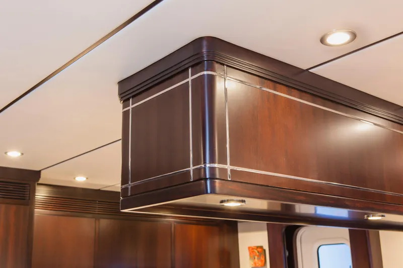  Yacht Photos Pics Luxurious interior of 2013 Nordhavn 68 yacht with elegant wood paneling and recessed lighting.