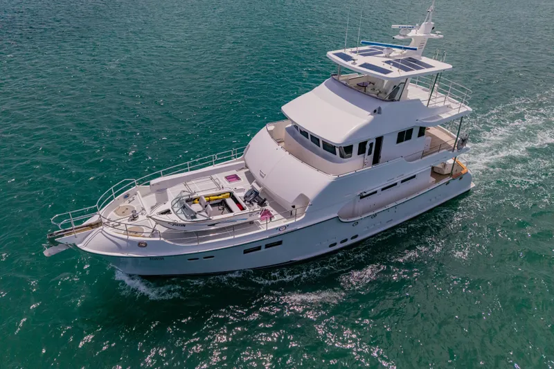  Yacht Photos Pics 2013 Nordhavn 68 yacht cruising on clear blue ocean waters.