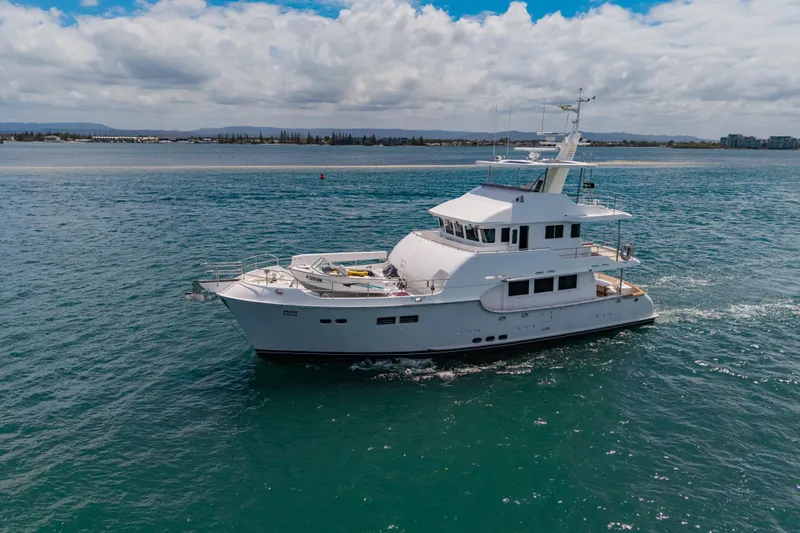  Yacht Photos Pics 2013 Nordhavn 68 yacht cruising on open water under a partly cloudy sky.