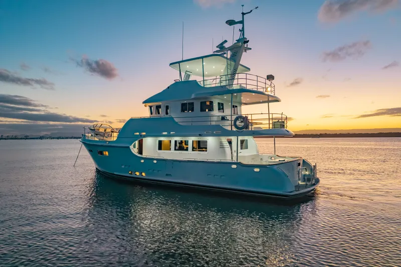  Yacht Photos Pics Luxurious 2013 Nordhavn 68 yacht at sunset on tranquil waters.