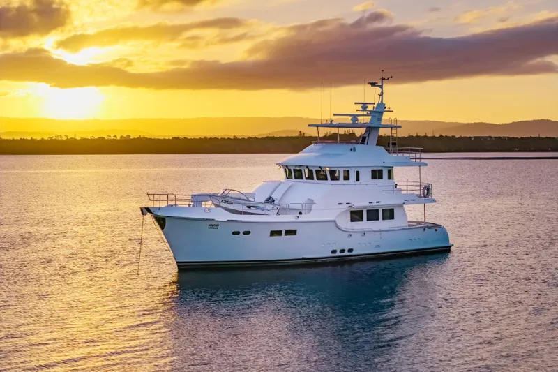  Yacht Photos Pics Luxurious 2013 Nordhavn 68 yacht at sunset on tranquil waters.