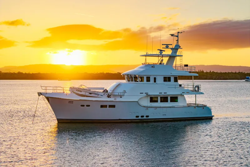  Yacht Photos Pics Nordhavn 68 yacht anchored at sunset, 2013 model, serene ocean view.