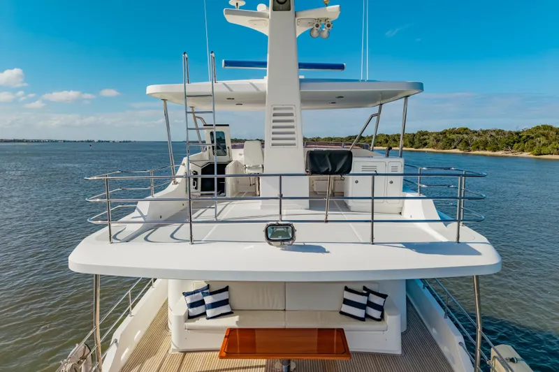  Yacht Photos Pics Luxurious 2013 Nordhavn 68 yacht on serene waters, featuring spacious deck and seating area.