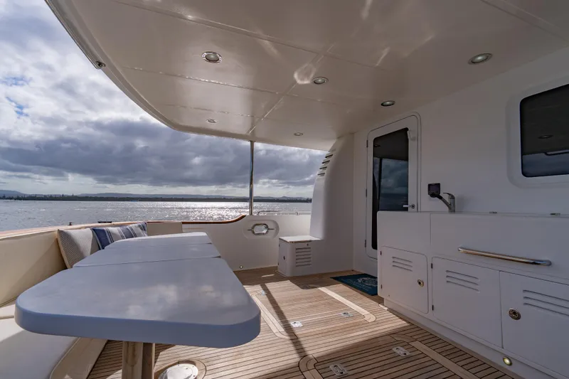  Yacht Photos Pics Spacious deck of 2013 Nordhavn 68 yacht with ocean view and seating area.