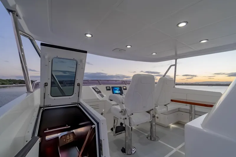  Yacht Photos Pics Pilothouse of 2013 Nordhavn 68 yacht at sunset, featuring modern navigation equipment.