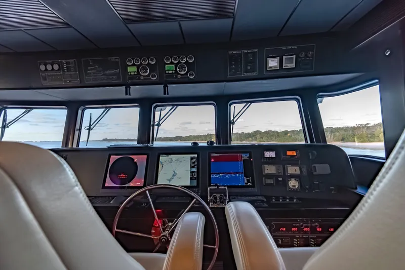  Yacht Photos Pics Cockpit of 2013 Nordhavn 68 yacht with navigation instruments and scenic view.