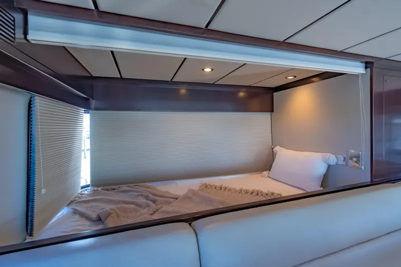  Yacht Photos Pics Cozy cabin interior of 2013 Nordhavn 68 yacht with bed and soft lighting.