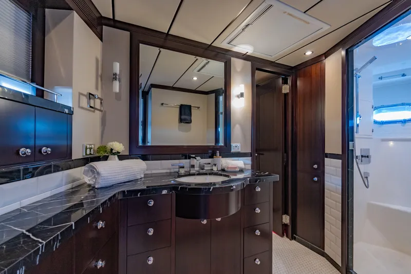  Yacht Photos Pics Luxurious bathroom interior of 2013 Nordhavn 68 yacht with elegant dark wood cabinetry.