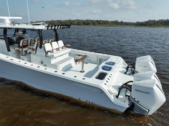  Yacht Photos Pics Freeman 47 boat, 2023 model, on water with dual Mercury engines.