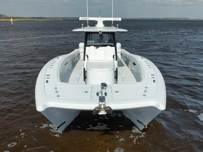  Yacht Photos Pics 2023 Freeman 47 boat on water, front view, sleek design, open sea background.