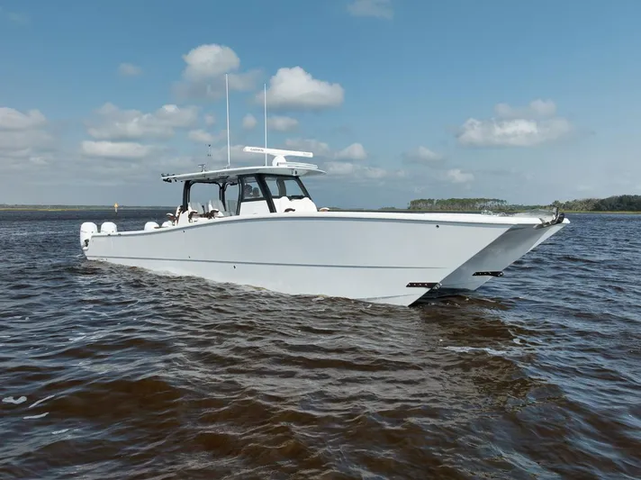  Yacht Photos Pics 2023 Freeman 47 boat cruising on open water under a clear sky.