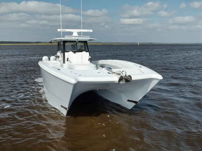  Yacht Photos Pics 2023 Freeman 47 boat on open water under a partly cloudy sky.