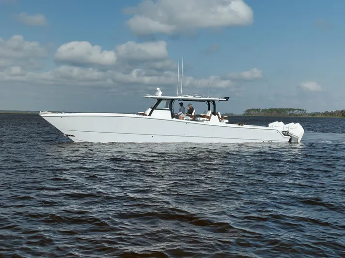  Yacht Photos Pics 2023 Freeman 47 boat cruising on open water under a cloudy sky.