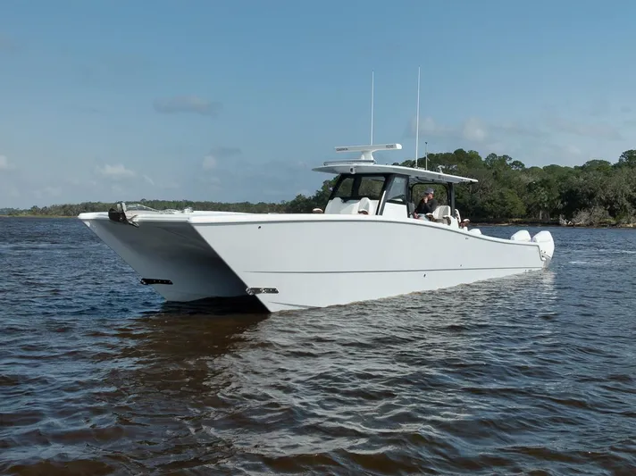  Yacht Photos Pics Freeman 47 boat cruising on a calm river, 2023 model.