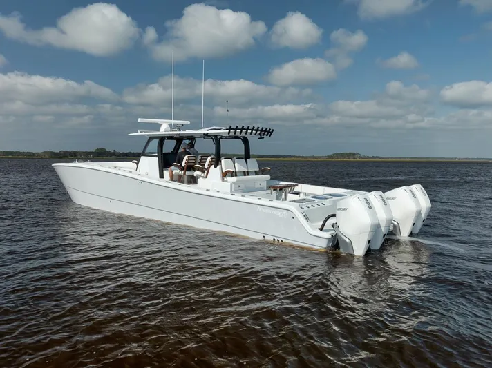  Yacht Photos Pics Freeman 47 boat, 2023 model, on calm water under a cloudy sky.