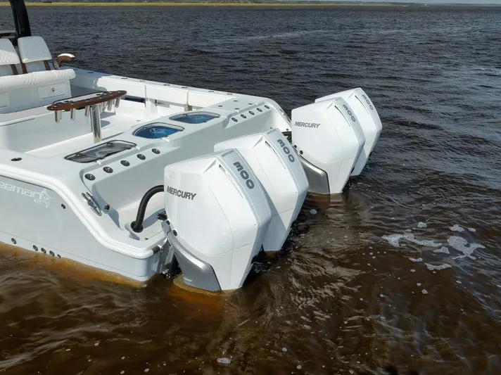  Yacht Photos Pics 2023 Freeman 47 boat with triple Mercury outboard engines on water.