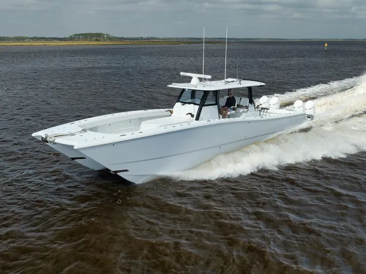  Yacht Photos Pics 2023 Freeman 47 boat cruising on open water, showcasing sleek design and performance.