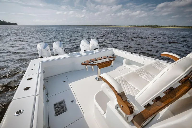  Yacht Photos Pics Freeman 47 boat, 2023 model, with luxurious seating and multiple engines on open water.