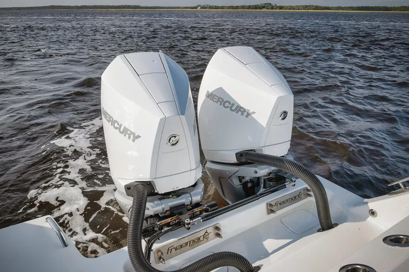  Yacht Photos Pics Twin Mercury outboard engines on a 2023 Freeman 47 boat, cruising on open water.