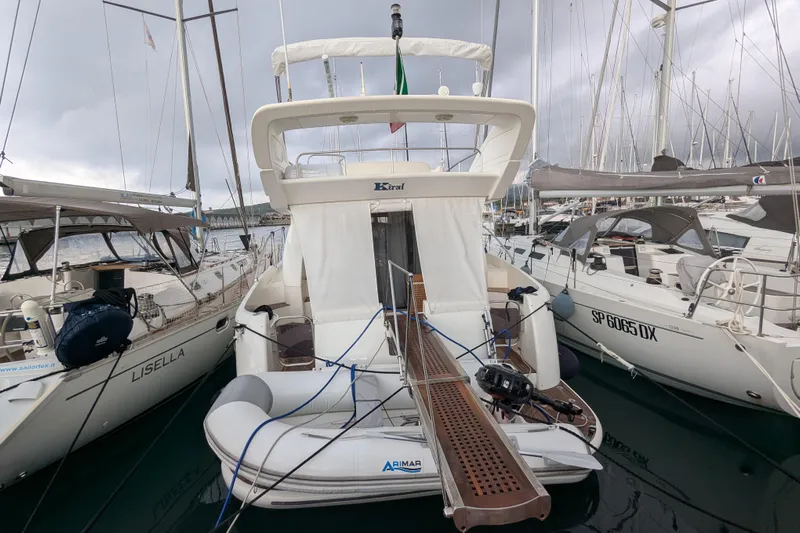  Yacht Photos Pics Azimut 46 yacht from 2000 docked between sailboats in a marina.