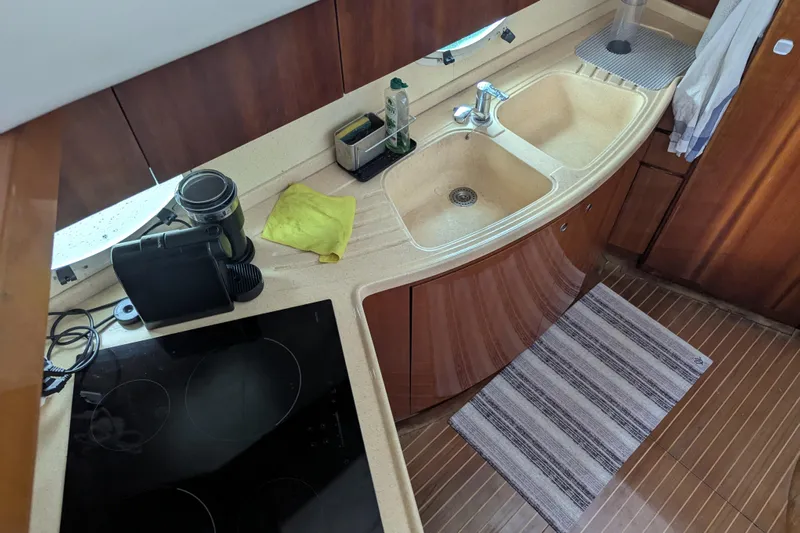  Yacht Photos Pics Kitchen area of a 2000 Azimut 46 yacht with sink and stove.