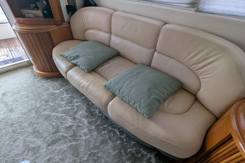  Yacht Photos Pics Luxurious beige leather sofa with green cushions in 2000 Azimut 46 yacht interior.