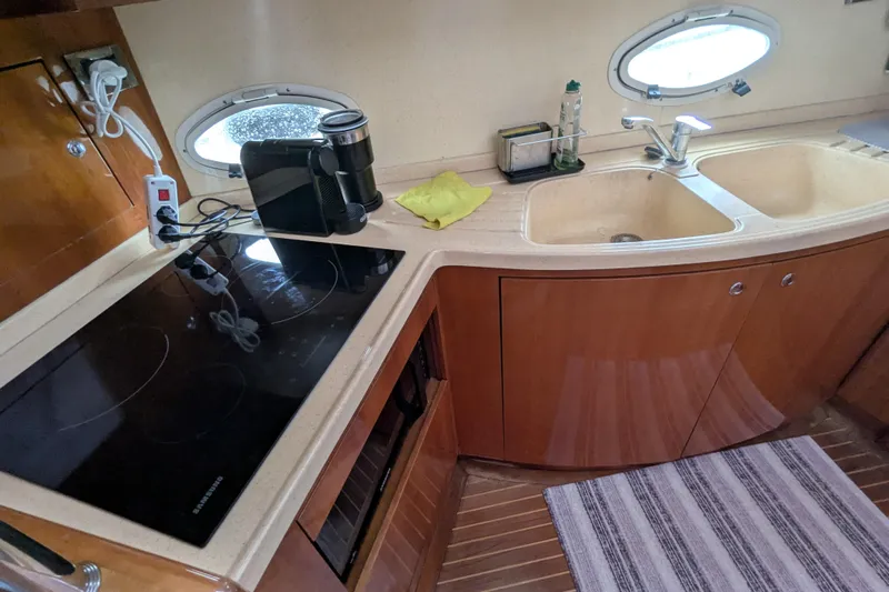 Yacht Photos Pics Kitchen area of a 2000 Azimut 46 yacht with stove and sink.