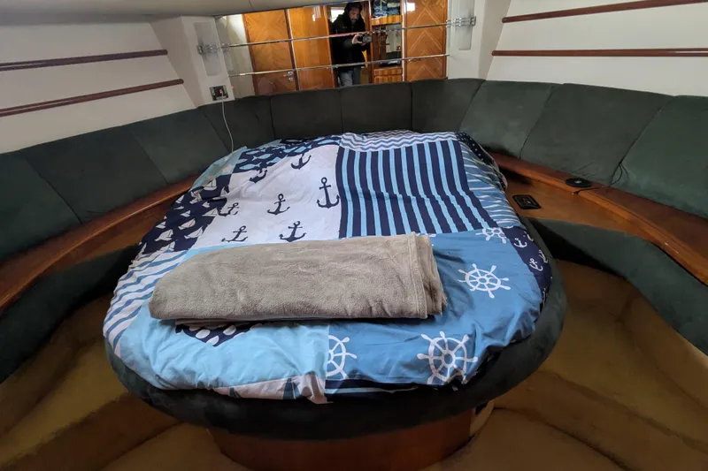  Yacht Photos Pics Cozy cabin interior of 2000 Azimut 46 yacht with nautical-themed bedding.