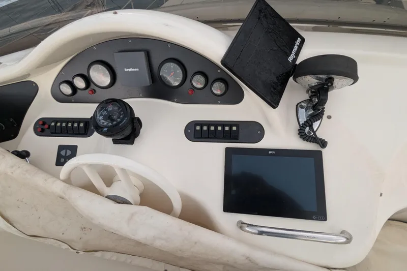  Yacht Photos Pics Control panel of a 2000 Azimut 46 yacht with navigation instruments and steering wheel.