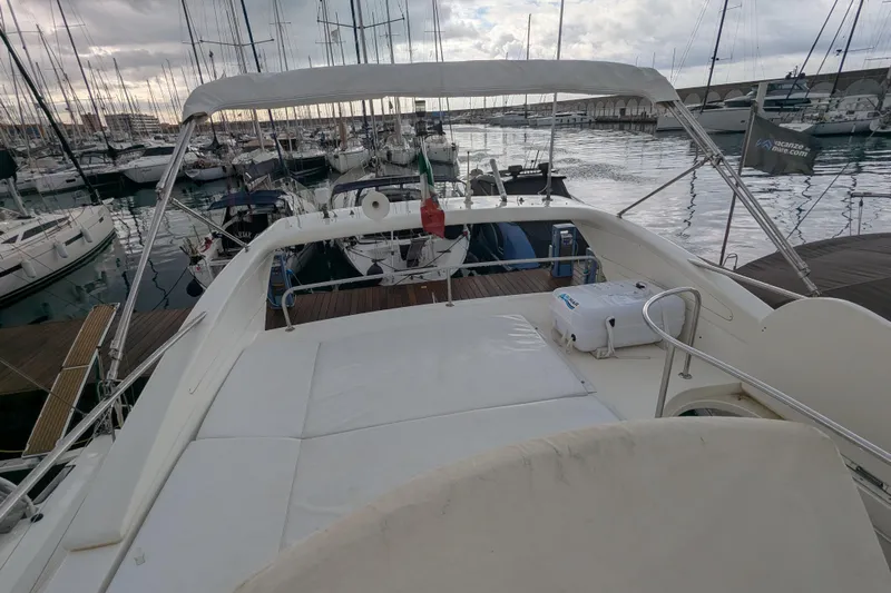  Yacht Photos Pics Azimut 46 yacht from 2000 docked in a marina, surrounded by sailboats.