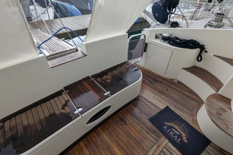  Yacht Photos Pics Azimut 46 yacht deck, 2000 model, featuring wooden flooring and seating area.