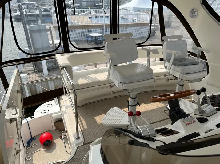  Yacht Photos Pics 2001 Sea Ray 560 Sedan Bridge cockpit with helm chairs and panoramic windows.