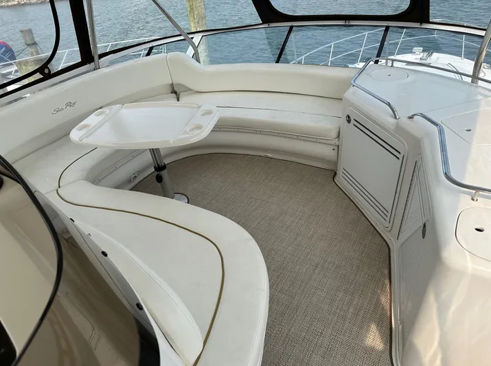  Yacht Photos Pics 2001 Sea Ray 560 Sedan Bridge interior seating area with table and ocean view.