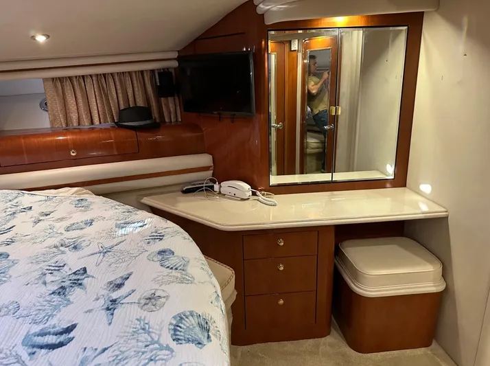  Yacht Photos Pics 2001 Sea Ray 560 Sedan Bridge bedroom with vanity, TV, and storage.