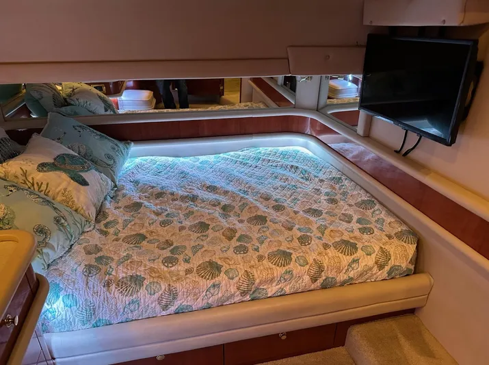  Yacht Photos Pics Luxurious bedroom interior of 2001 Sea Ray 560 Sedan Bridge yacht with TV and cozy bedding.