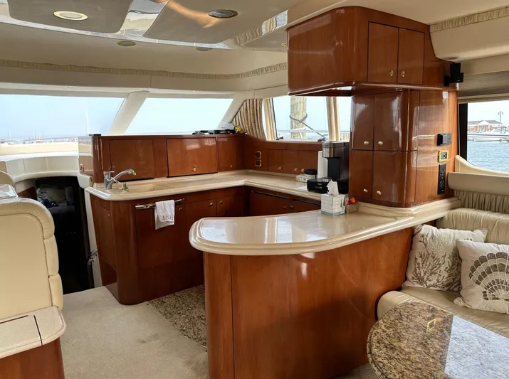  Yacht Photos Pics Luxurious kitchen area in a 2001 Sea Ray 560 Sedan Bridge yacht with wooden cabinetry.