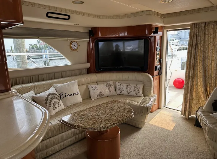  Yacht Photos Pics Luxurious interior of a 2001 Sea Ray 560 Sedan Bridge yacht with plush seating and a TV.