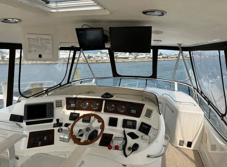  Yacht Photos Pics 2001 Sea Ray 560 Sedan Bridge helm with navigation equipment and panoramic water view.