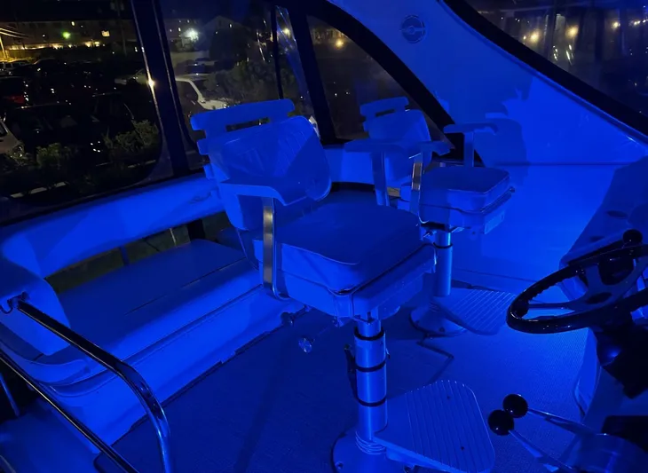  Yacht Photos Pics Interior of 2001 Sea Ray 560 Sedan Bridge yacht illuminated in blue light.