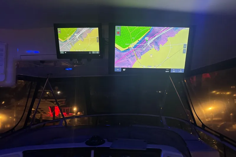  Yacht Photos Pics 2001 Sea Ray 560 Sedan Bridge cockpit with illuminated navigation screens at night.