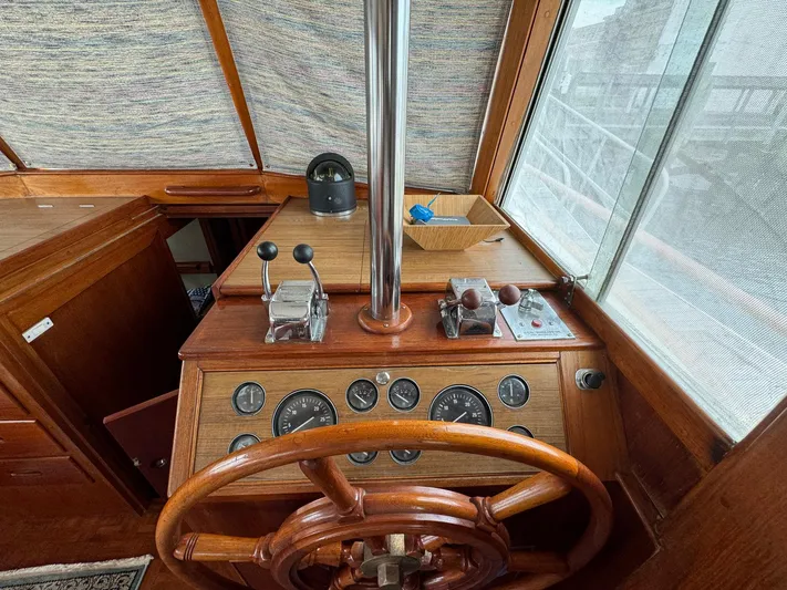 Carolina Breeze Yacht Photos Pics 1989 Grand Banks 42 Motor Yacht helm with wooden wheel and control panel.