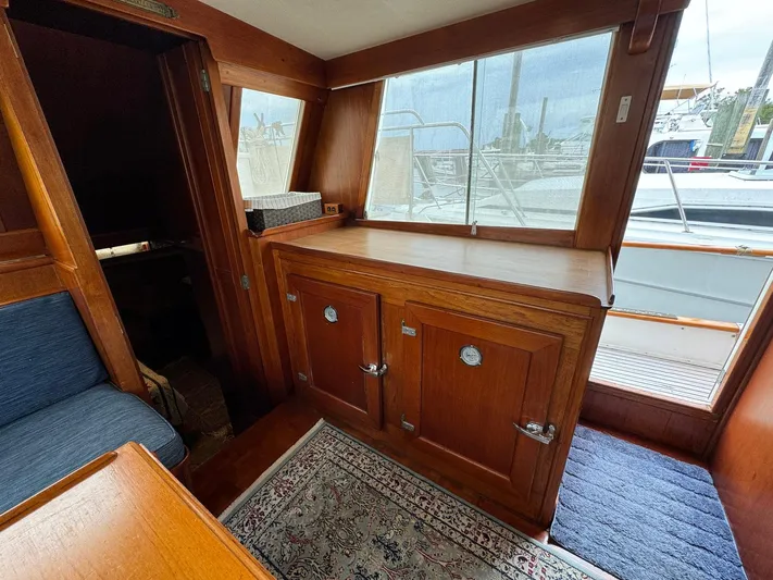 Carolina Breeze Yacht Photos Pics Interior of 1989 Grand Banks 42 Motor Yacht with wooden cabinetry and nautical decor.