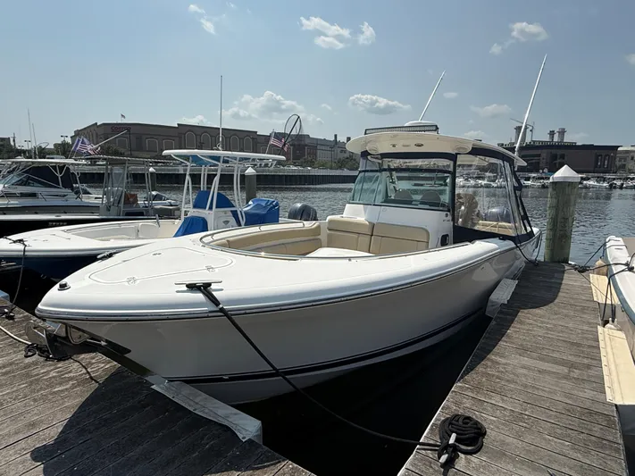 Savages Yacht Photos Pics 2015 Pursuit ST 310 Sport boat docked at marina under clear sky.