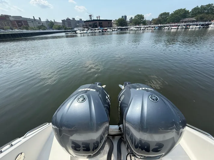 Savages Yacht Photos Pics 2015 Pursuit ST 310 Sport boat with dual Yamaha outboard motors on a calm river.