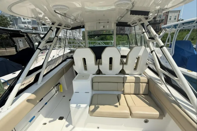 Savages Yacht Photos Pics 2015 Pursuit ST 310 Sport boat interior with seating and helm, docked at marina.
