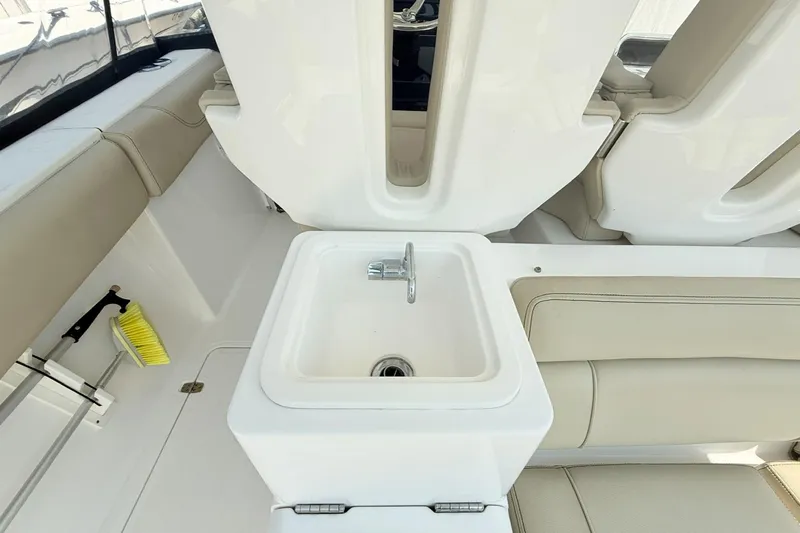 Savages Yacht Photos Pics Interior of 2015 Pursuit ST 310 Sport boat with sink and seating area.
