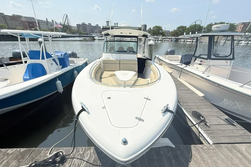 Savages Yacht Photos Pics 2015 Pursuit ST 310 Sport boat docked at marina, surrounded by other boats.