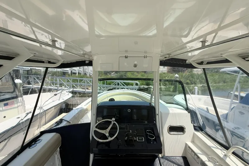 Savages Yacht Photos Pics 2015 Pursuit ST 310 Sport boat interior with steering wheel and control panel.